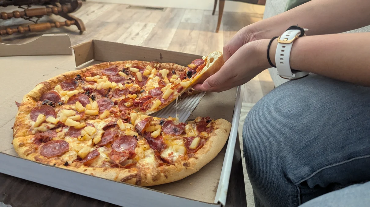 Brenda grabbing a slice