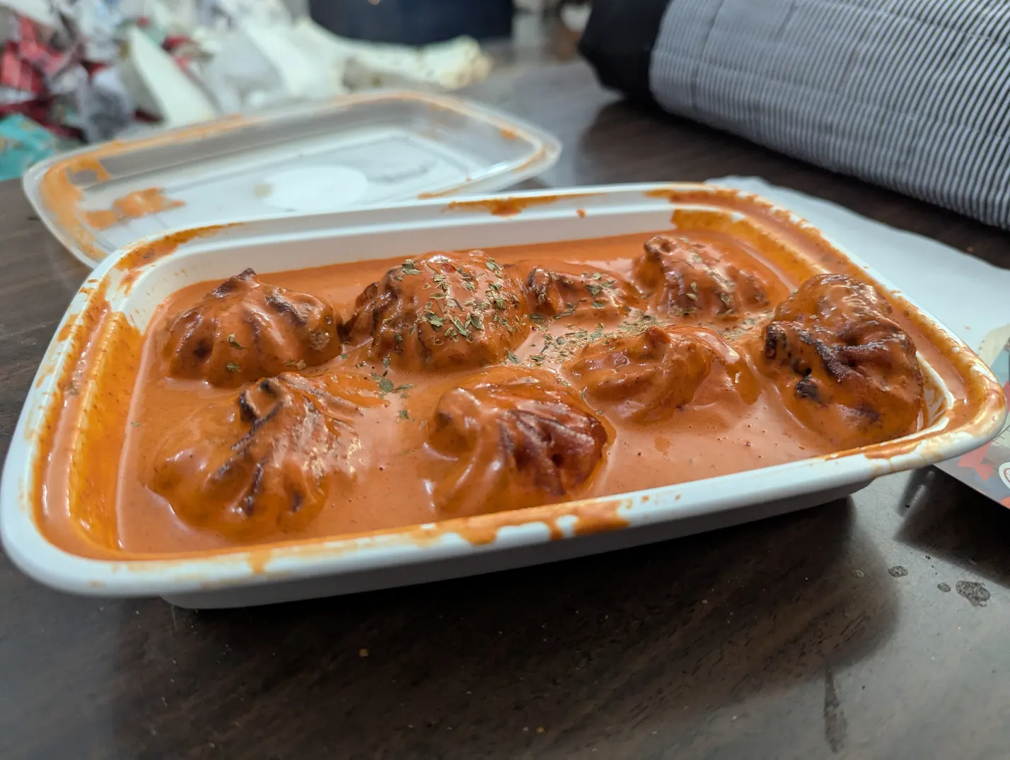 A close up of the orange gravy momo's